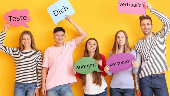 Drei junge Frauen und zwei junge Männer halten Schilder in die Kamera mit den Worten: Teste Dich anonym, kostenlos, vertraulich.