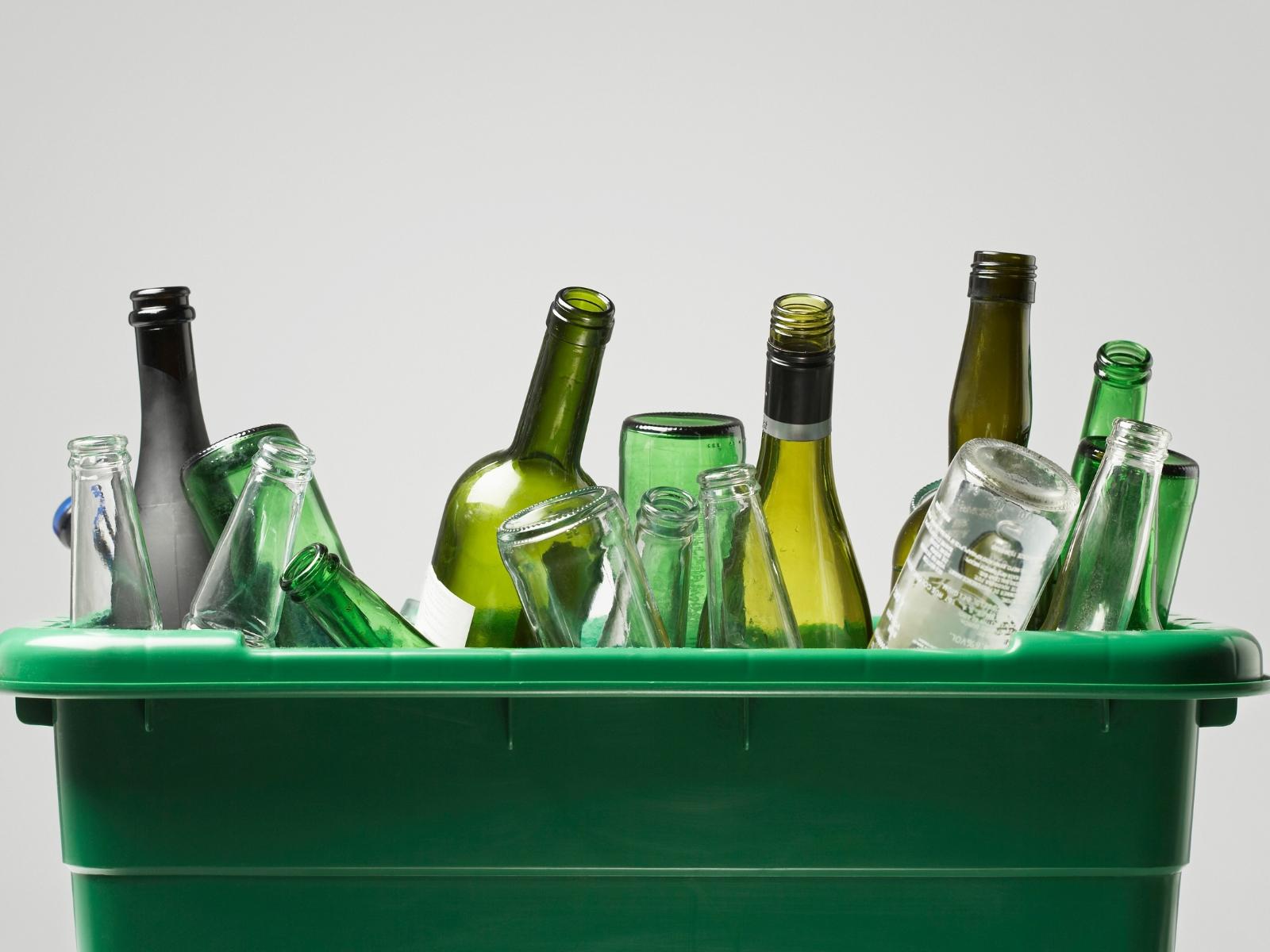 Ein Korb gefüllt mit Glasflaschen in verschiedenen Farben.