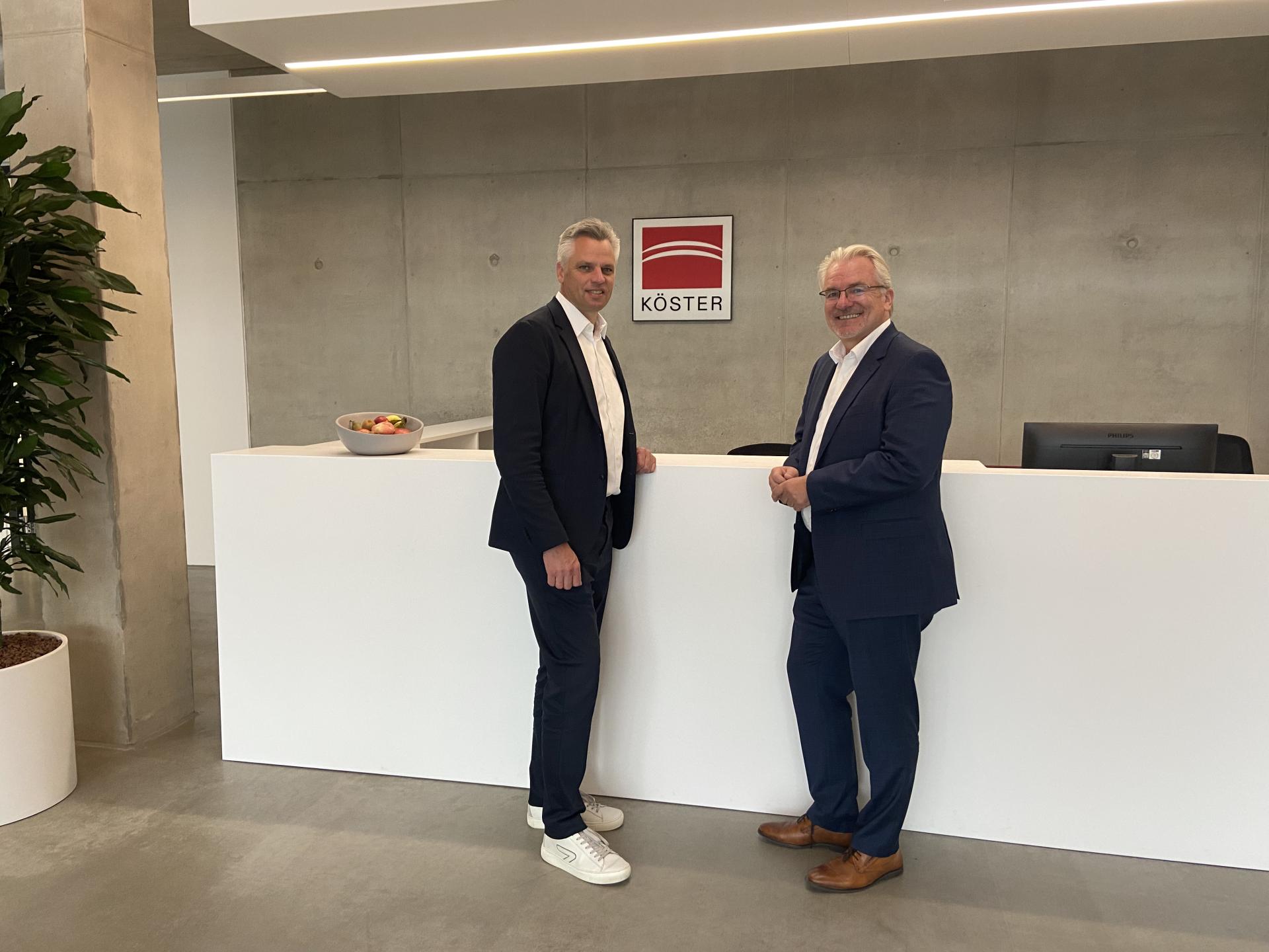 Oberbürgermeister Marc Buchholz (rechts) steht mit dem Geschäftsführer der Firma Köster GmbH am Empfang