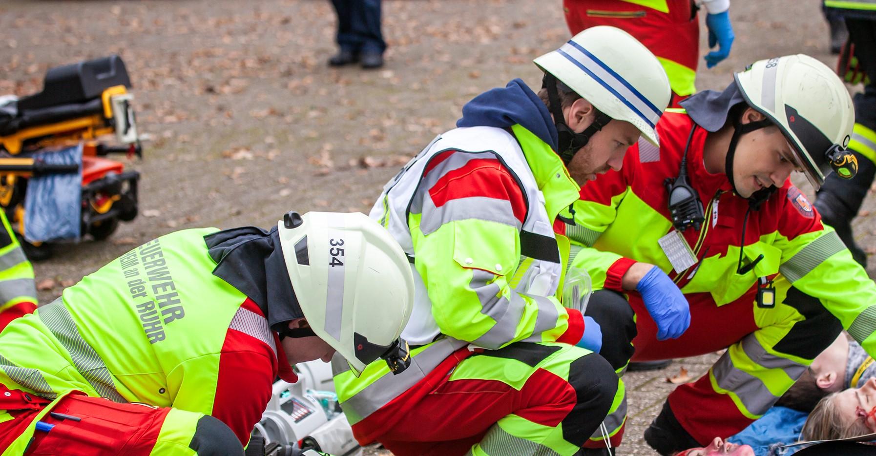 Das Bild zeigt mehrere Feuerwehrleute bei der Versorgung eines Verletzten
